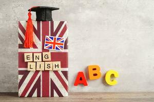 English book with graduate hat, learning and tutorial for foreigner. photo