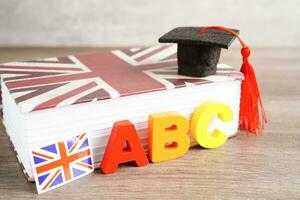 English book with graduate hat, learning and tutorial for foreigner. photo