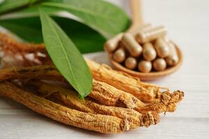 Ginseng roots and green leaf, healthy food. photo