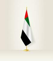 unido árabe emiratos bandera en un bandera pararse. vector