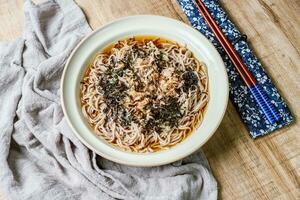 Korean food Naengmemilguksu, a winter delicacy, this buckwheat noodle dish is served in a cold chicken- or beef-based broth and topped with cold slices of beef and egg as a garnish. photo