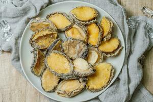 Seafood on a plate raw abalone photo