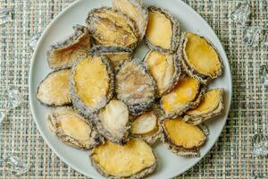 Seafood on a plate raw abalone photo