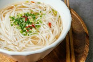 Vietnamese food rice noodle dish in a white bowl photo