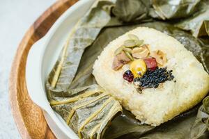 yeonnipbap, korean lotus leaf rice, Glutinous rice, dates, and chestnuts wrapped in a lotus leaf and steamed in a steamer. In the past, this dish was made and consumed by Buddhist monks, photo