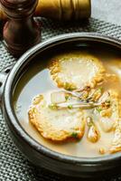 Korean fish cake soup served in a black clay pot photo