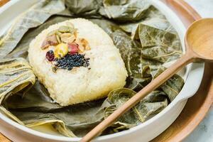yeonnipbap, korean lotus leaf rice, Glutinous rice, dates, and chestnuts wrapped in a lotus leaf and steamed in a steamer. In the past, this dish was made and consumed by Buddhist monks, photo
