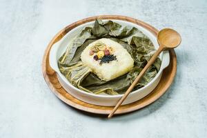 yeonnipbap, korean lotus leaf rice, Glutinous rice, dates, and chestnuts wrapped in a lotus leaf and steamed in a steamer. In the past, this dish was made and consumed by Buddhist monks, photo