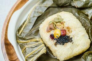 yeonnipbap, korean lotus leaf rice, Glutinous rice, dates, and chestnuts wrapped in a lotus leaf and steamed in a steamer. In the past, this dish was made and consumed by Buddhist monks, photo