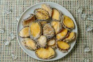 Seafood on a plate raw abalone photo