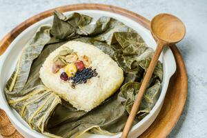 yeonnipbap, korean lotus leaf rice, Glutinous rice, dates, and chestnuts wrapped in a lotus leaf and steamed in a steamer. In the past, this dish was made and consumed by Buddhist monks, photo