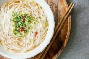 Vietnamese food rice noodle dish in a white bowl photo