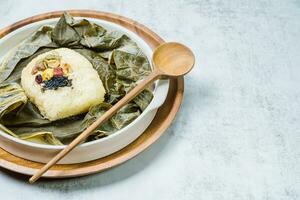 yeonnipbap, korean lotus leaf rice, Glutinous rice, dates, and chestnuts wrapped in a lotus leaf and steamed in a steamer. In the past, this dish was made and consumed by Buddhist monks, photo