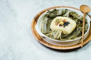 yeonnipbap, korean lotus leaf rice, Glutinous rice, dates, and chestnuts wrapped in a lotus leaf and steamed in a steamer. In the past, this dish was made and consumed by Buddhist monks, photo