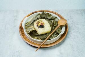yeonnipbap, korean lotus leaf rice, Glutinous rice, dates, and chestnuts wrapped in a lotus leaf and steamed in a steamer. In the past, this dish was made and consumed by Buddhist monks, photo