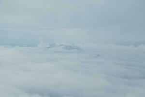 Mountain range with visible silhouettes through the morning blue fog. photo