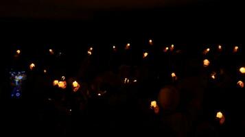 Candles glowing against dark background closeup photo