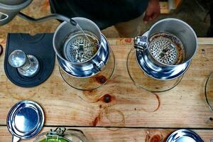 coffee is being poured, showing coffee drops and puffs of steam photo