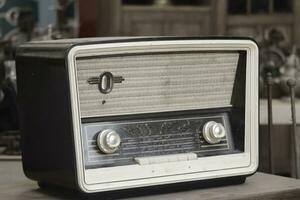 Retro broadcast radio receiver on wooden table circa 1950 photo