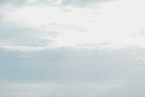 Mountain range with visible silhouettes through the morning blue fog. photo