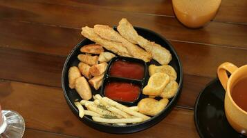 French fries, Nuggets and delicious fried otak otak served with Spicy Sauce photo