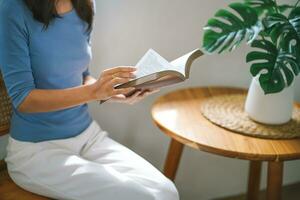 Women reading book and relaxing at home and comfort in front of opened book photo