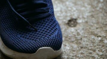 blue sport shoes, blue sneakers on dirty floor photo