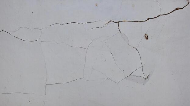 Cement wall collapse. Cracked concrete old wall. dangerous, damaged building structure. photo