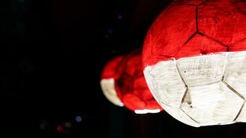 red and white balls hanging on a black background photo