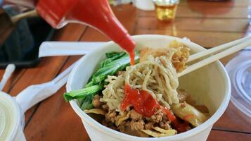 Chicken noodles in a plastic bowl packaging photo