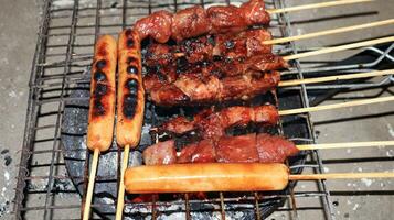 sausages and meat grilled over the fireplace with spicy soy sauce photo