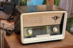 Retro broadcast radio receiver on wooden table circa 1950 photo