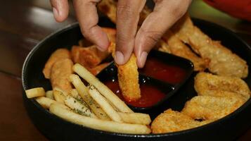 francés papas fritas, pepitas y delicioso frito otak otak servido con picante salsa foto