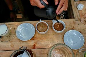 coffee is being poured, showing coffee drops and puffs of steam photo