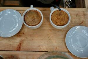 coffee is being poured, showing coffee drops and puffs of steam photo