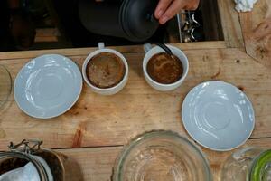 coffee is being poured, showing coffee drops and puffs of steam photo