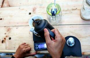 coffee is being poured, showing coffee drops and puffs of steam photo