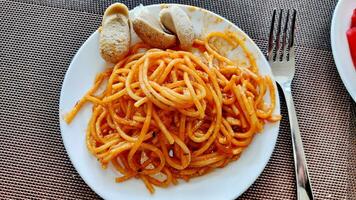 Delicious spaghetti bolognese served on a white plate photo