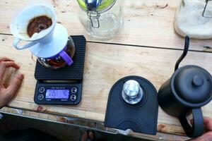 coffee is being poured, showing coffee drops and puffs of steam photo