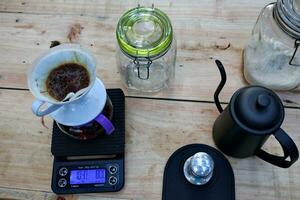 coffee is being poured, showing coffee drops and puffs of steam photo