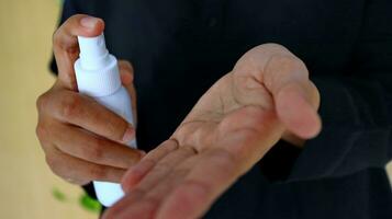 Hand of lady that applying alcohol spray or anti-bacteria spray to prevent the spread of germ photo