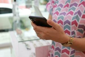 Smartphone in hand with blur background photo