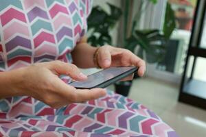 Smartphone in hand with blur background photo