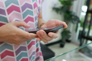 Smartphone in hand with blur background photo