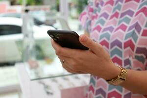 Using phone, holding smartphone, mobile phone in hand photo