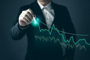 man draw graphs and progress of business and analyze financial,and investment.Use technology to plan strategy to success goals and growth stock.online business,e-commerce,online marketing. photo