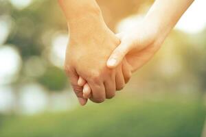 Woman and man holding hands, Happy couple love in the garden. concept couple lover valentine day photo