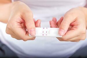 Young women checking pregnancy test. photo