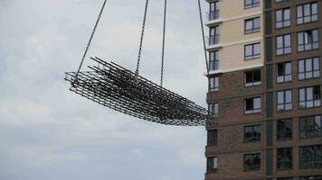 At the construction site, a crane moves the load video