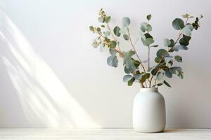 Eucalyptus branch with modern vase in mediterranean white surrounding. AI Generated photo